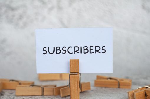 istock image: clothes pin holding a sign labeled "subscribers"